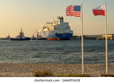 Swinoujscie,Poland-26 July 2019:The US And Polish Flags And The American LNG Tanker During The Supply Of Liquefied Gas To The LNG Terminal In Świnoujście In Poland As Part Of A Multi-annual Agreement 