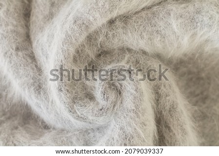 Swirl of gray alpaca fabric and mohair wool sweater texture