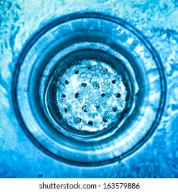 Swirl Of Water Going Down A Stainless Steel Sink