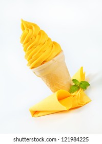 Swirl Of Yellow Soft Serve Ice Cream In A Cone
