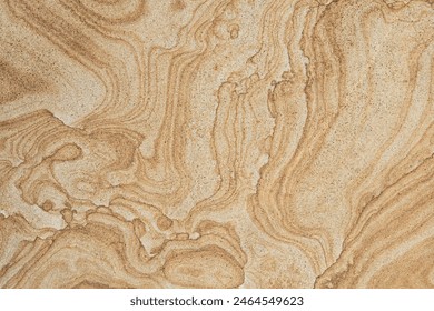 Swirled sandstone surface with intricate patterns, showcasing a natural and earthy texture suitable for design and architectural use. - Powered by Shutterstock