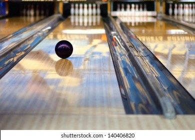 Swirling Bowling Ball Is Rolling Down The Path To The Bowling Pins