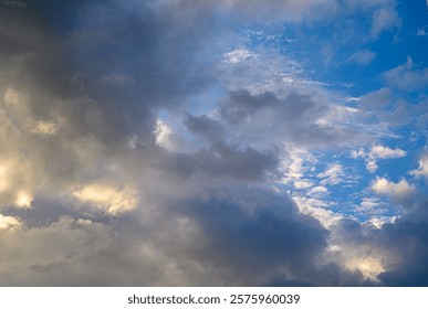 Swirling clouds create a captivating tapestry as the sun sets, painting the sky with hues of blue and gray.