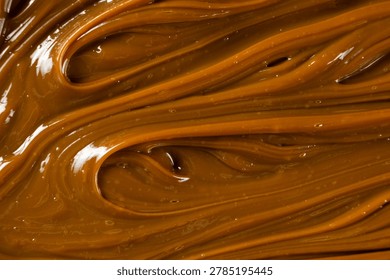 Swirling dulce de leche pattern close up for dessert