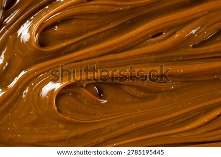 Swirling dulce de leche pattern close up for dessert