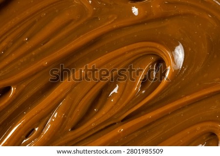Swirling dulce de leche pattern close up for dessert