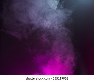 Swirling fog lit with pink and blue gels to create a multicolored background texture.  - Shutterstock ID 335119952