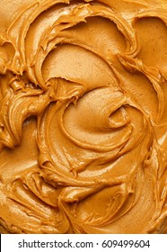 Swirls of creamy peanut butter spread. 