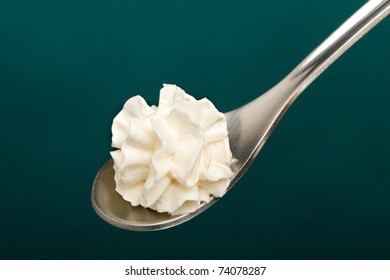 Swirls Of Whipped Cream In A Spoon