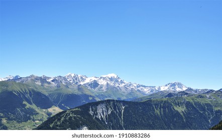 Swiss Alps peaks and ridges covered in snow in Summer. Stunning mountain landscape in Switzerland. Panoramic shot. Space for copy. 