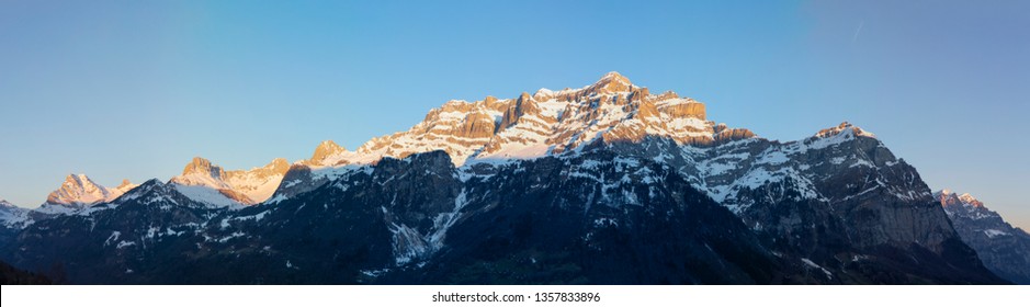 Swiss Alps Sunrise with mountain glowing. Glarus Central Switzerland