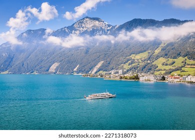 Swiss alps and turquoise lake Lucerne with ferry boat arriving at harbor, Switzerland - Powered by Shutterstock