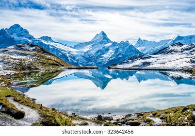 Swiss alps water reflection in  Bachalpsee - mountain lake above Grindelwald, Switzerland. - Shutterstock ID 323642456
