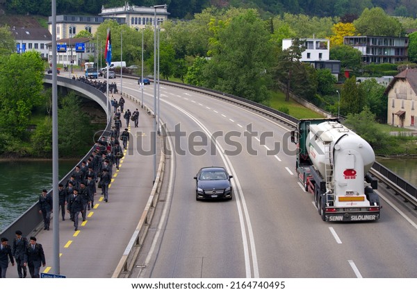 Swiss Army\
soldiers walking to railway station at City of Brugg, Canton\
Aargau, to start their weekend holiday on a blue cloudy spring day.\
Photo taken May 6th, 2022, Brugg,\
Switzerland.