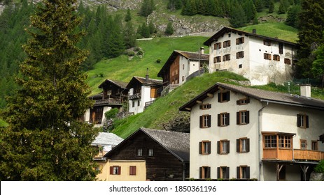 Swiss Chalet Houses On Mountain Slope.