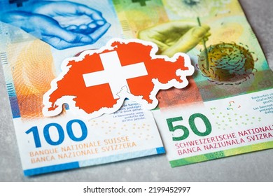 Swiss flag against the background of Swiss francs, currency security concept