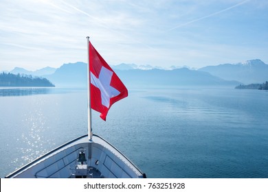 Swiss Flag Flying On Boat And Rigi Mountain View Background