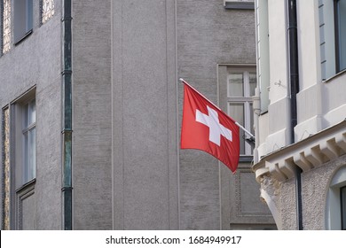 Swiss Flag hanging from Building Facade.