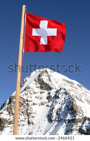 the swiss flag on a background of beautiful mountain peaks