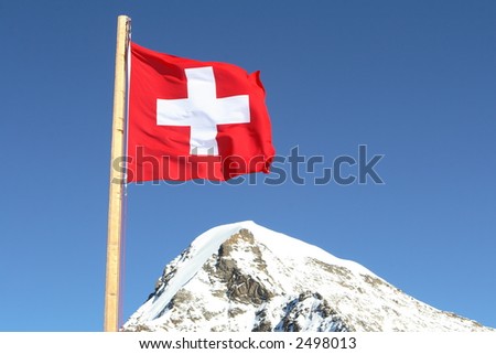 the swiss flag on a background of beautiful mountain peaks