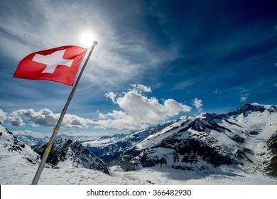 Swiss Flag On The Top Of The Mountain.