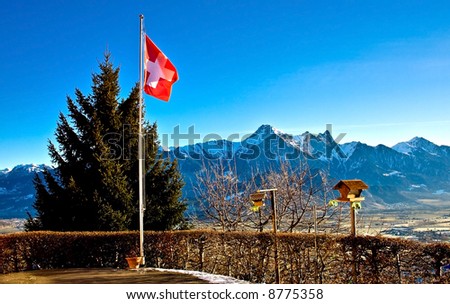 Swiss flag over mountains