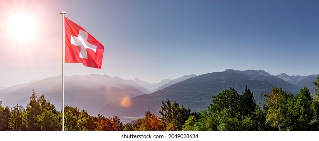 Swiss flag in Valais in front of Rhone valley - Shutterstock ID 2049028634