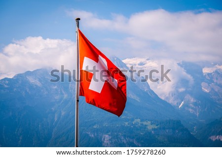 Swiss flag waving  with Mountains background