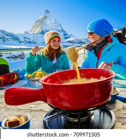 Swiss Fondue Cheese - Skiers Enjoying Break For Lunch, Mountain View Matterhorn, Switzerland.