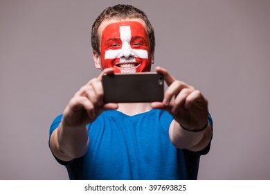 Swiss Football Fan Take Selfie Photo With Phone On Grey Background. European 2016 Football Fans Concept.