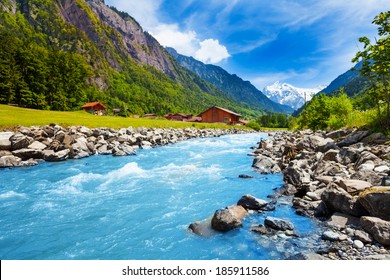 Swiss landscape with river stream and houses
