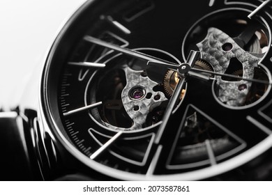 Swiss Mechanical Skeleton Wrist Watch With Black Metal Deal And Shiny High-tech Ceramic Body. Close-up Photo. It Is A Watch Type In Which All Of The Moving Parts Are Visible