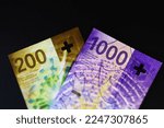 Swiss money, a business background. Swiss banknotes on black background.