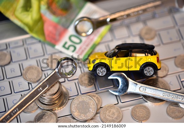 swiss money with pc keyboard and car mechanic work\
spanner tools
