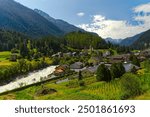 Swiss mountain village Zernez with church and Wildenberg Castle at Engadin Valley in the Swiss Alps on a sunny summer day. Photo taken July 19th, 2024, Zernez, Switzerland.