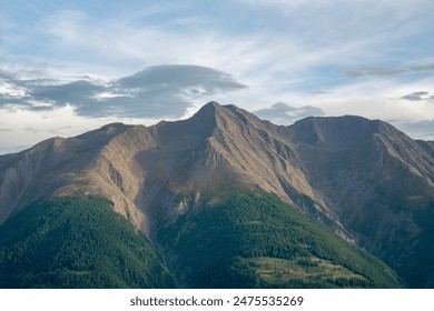 Swiss Bättlihorn peak in early September in the evening. The image showcases the natural beauty of the mountain with its rugged slopes and rocky peaks. The sky is partly cloudy. - Powered by Shutterstock