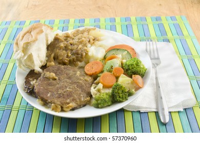 Swiss Steak Iwht Mashed Potatoes And Gravy, Steamed Vegetables, And Soft Roll