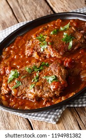 Swiss Steak Is Meat Beef Braising In A Pan Of Stewed Tomatoes, Mushroom Sauce Closeup On The Table. Vertical
