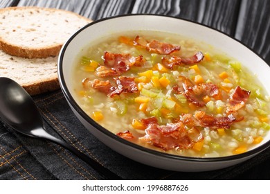 Swiss style Bundner Gerstensuppe hearty Barley Soup close up in the plate on the table. Horizontal - Shutterstock ID 1996887626