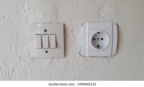 Switch and Electric socket and white wall