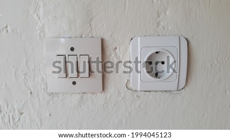 Switch and Electric socket and white wall
