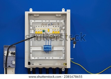 Switch electrical box. Panel with automatic devices for controlling electricity. Metal power cabinet in wall. Electrical panel for automation equipment. Small power cabinet with automatic machines 商業照片 © 