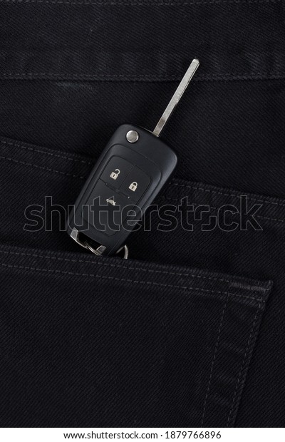 Switch key is lying in side pocket of black\
pants. Modern lifestyle.
