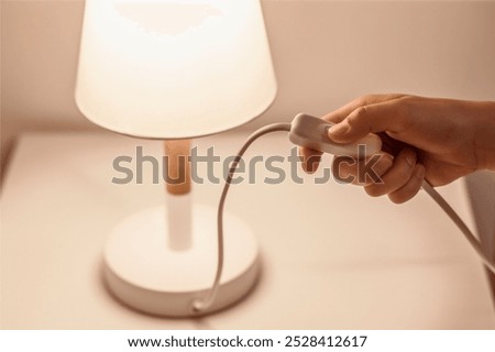 Switch off the Light on Table Lamp in Bedroom. Energy Saving and Blackout concept. Turn off Point Lights.