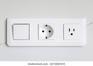 Switch and sockets. White module. Modern wall