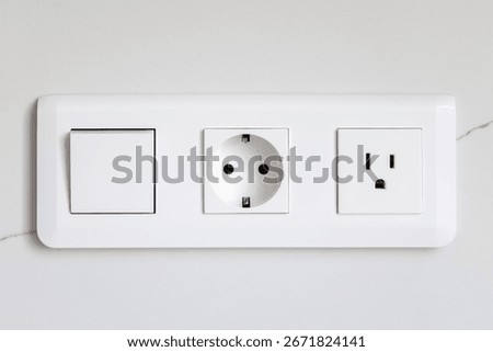 Switch and sockets. White module. Modern wall