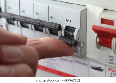 Switching an MCB (Micro Circuit Breaker) on a UK domestic electrical consumer unit or fuse box - Shutterstock ID 497967832