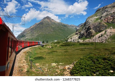 Switzerland: July 2012, Famous red alpine train Bernina Express (from St.Moritz to Tirano) near Bernina Pass (Switzerland)