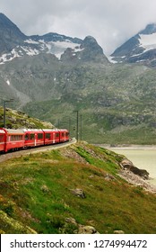 Switzerland: July 2012, Famous red alpine train Bernina Express (from St.Moritz to Tirano) near Bernina Pass (Switzerland)