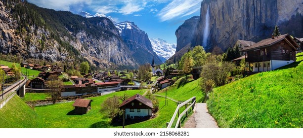 Switzerland nature and travel. Alpine scenery. Scenic traditional mountain village lauterbrunnen with waterfall  surrounded by snow peaks of Alps. Popular tourist destination and ski resort